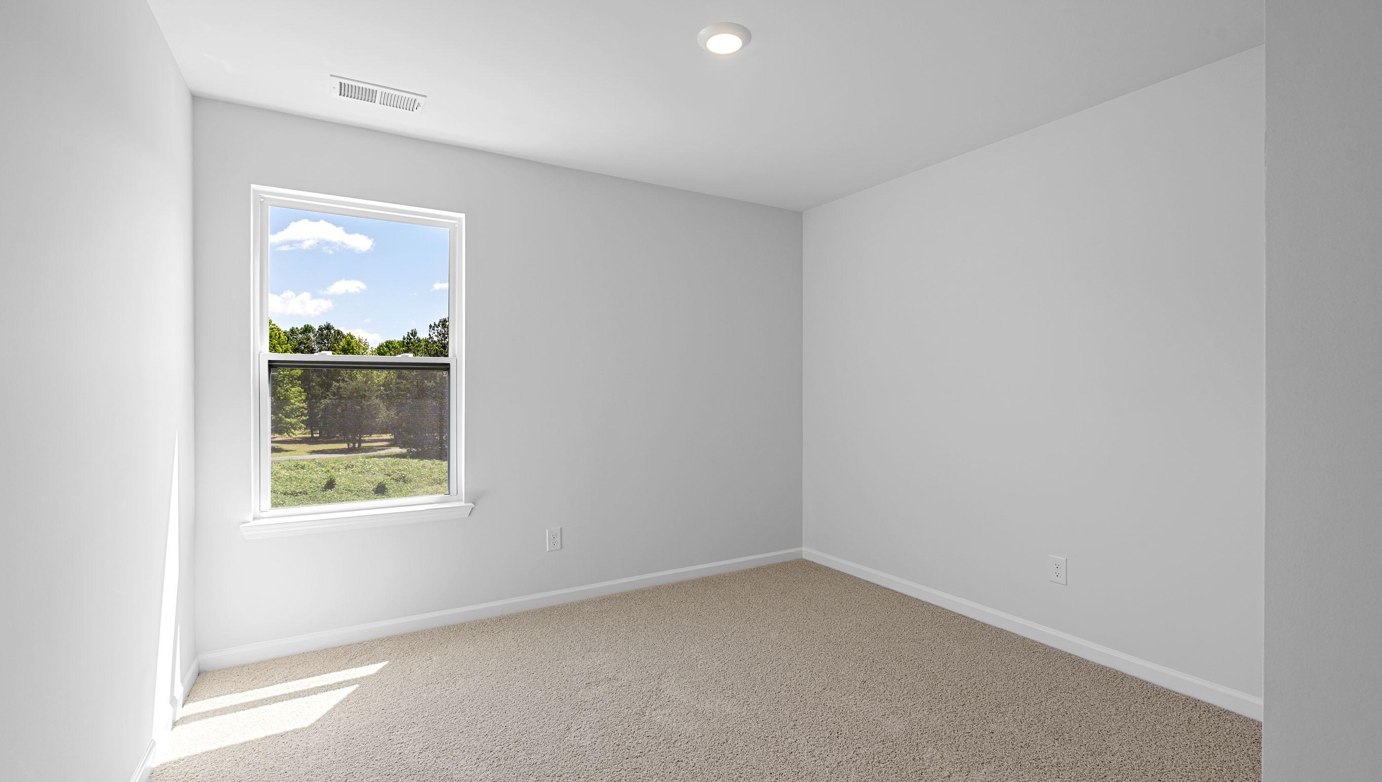 Bedroom with carpet and window.