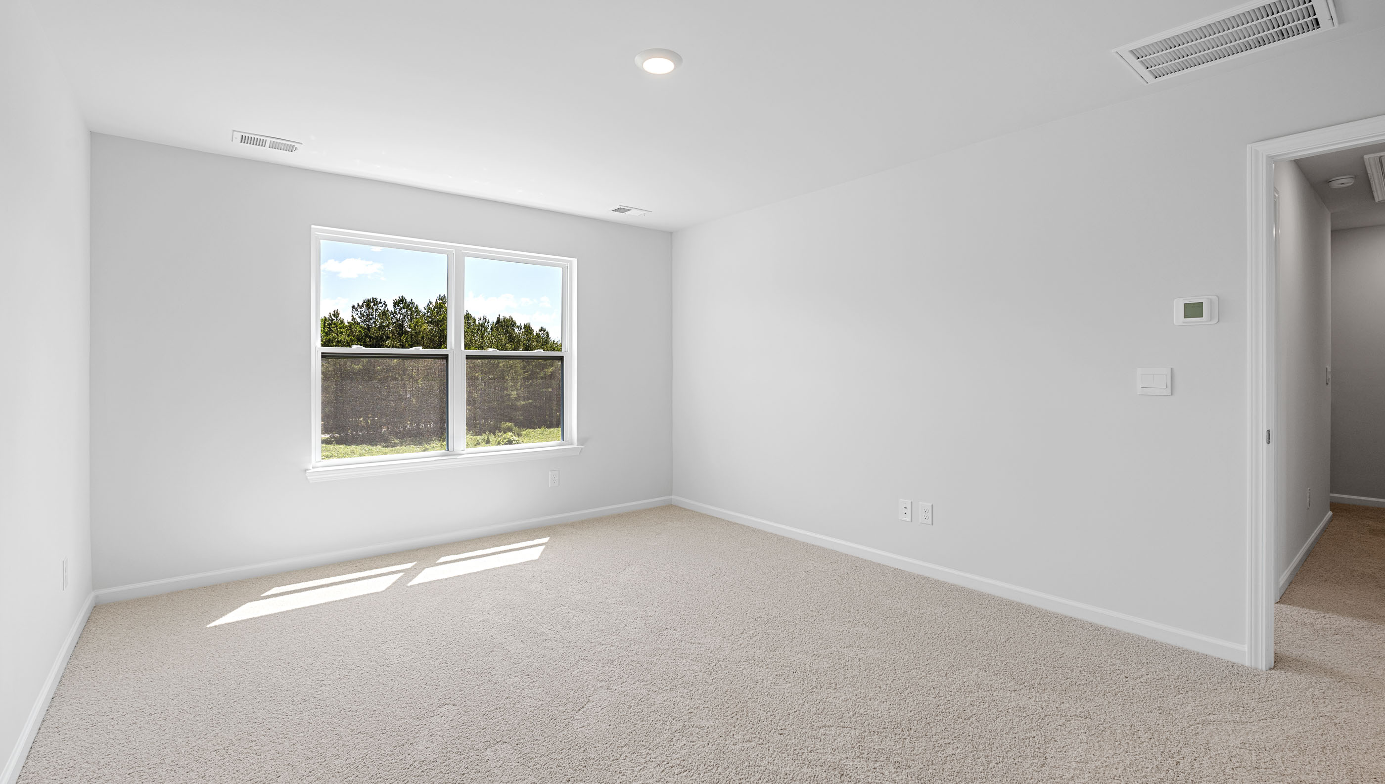 Bedroom with carpet and window.