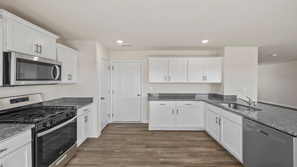 Kitchen with granite countertops and stainless steel appliances.