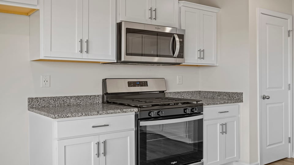 Kitchen with granite countertops and stainless steel appliances.