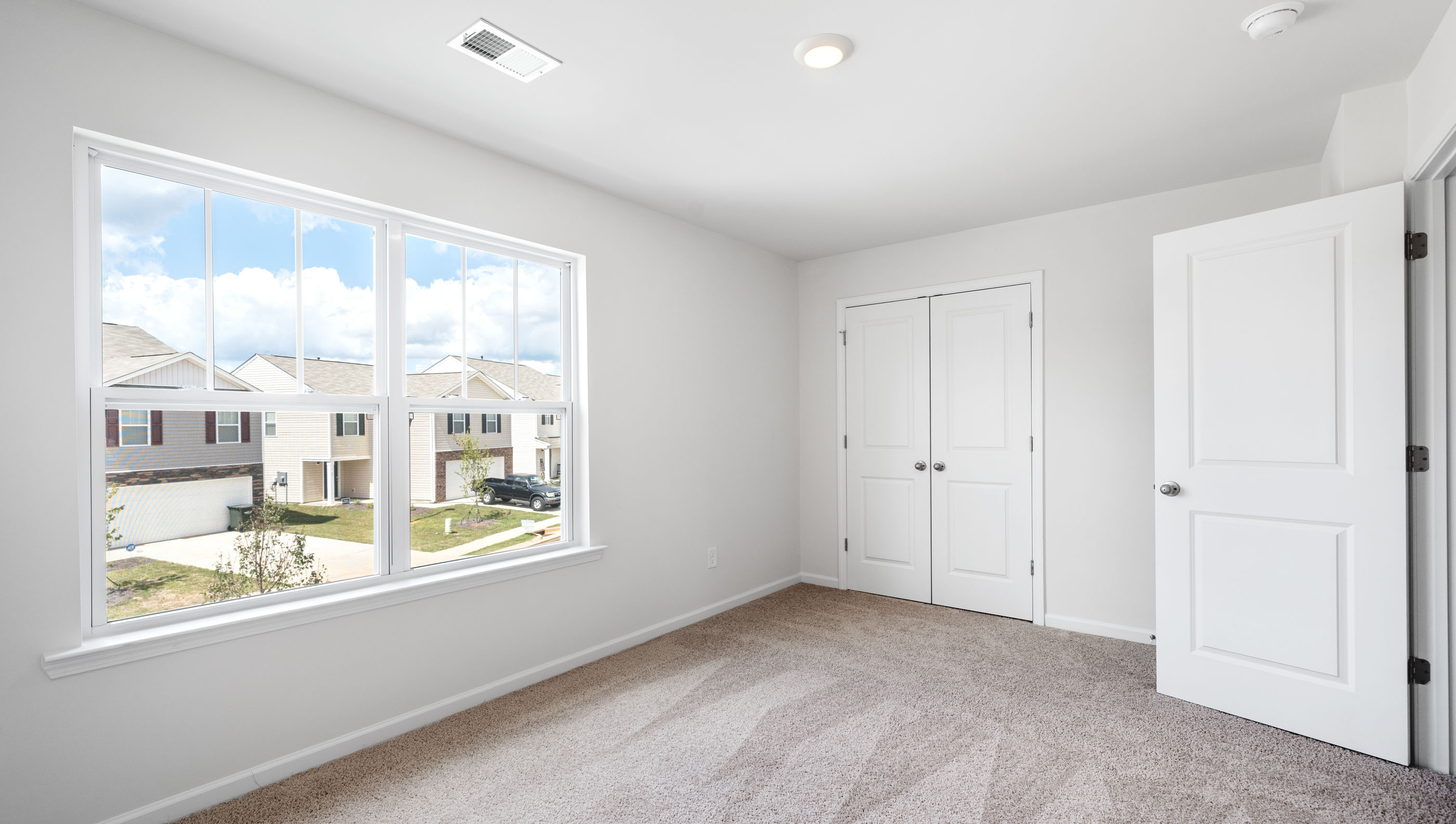 Bedroom 2 with large window.
