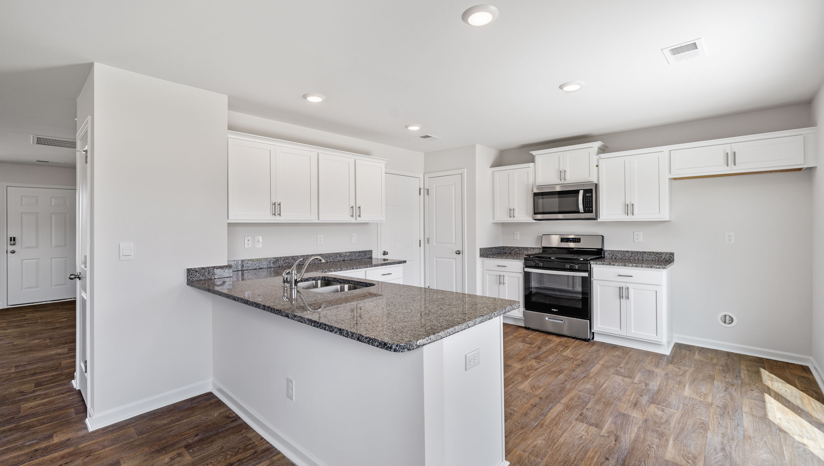 Kitchen and island with granite counter tops.