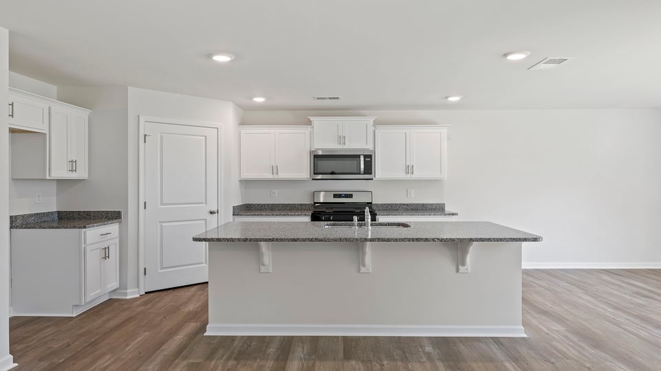 Kitchen and island with granite countertops.