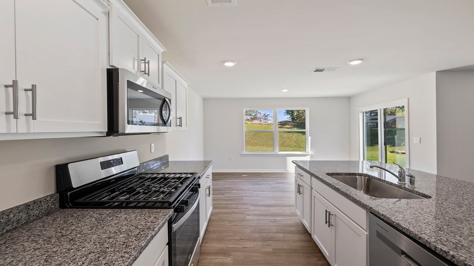 Kitchen and island with granite countertops.