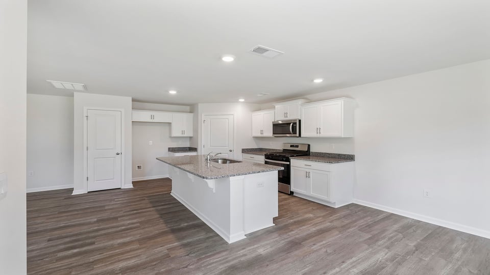 Kitchen and island with granite countertops.