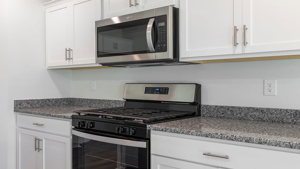 Kitchen with granite countertops and stainless steel appliances.