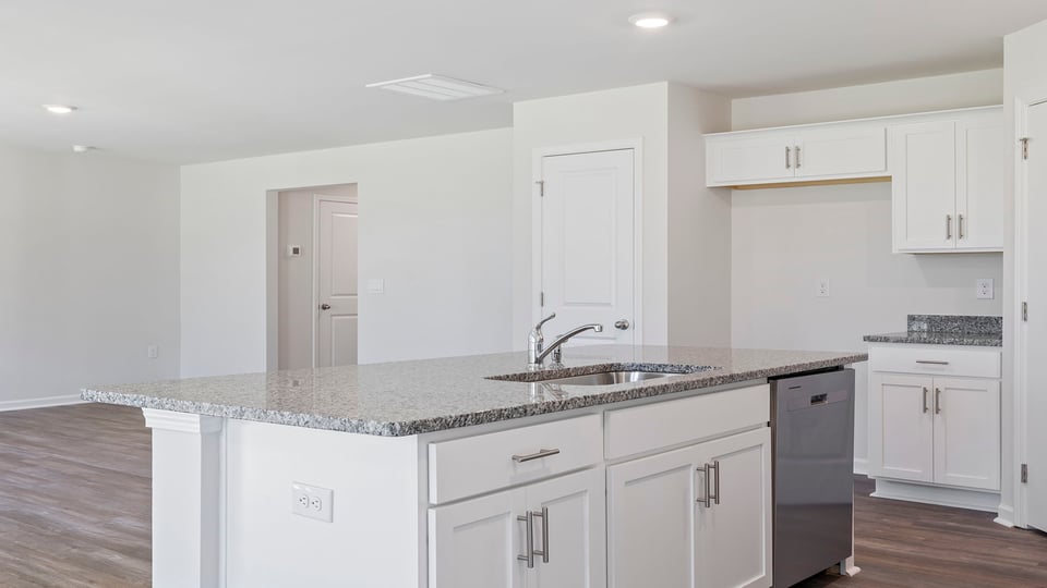 Kitchen and island with granite countertops.