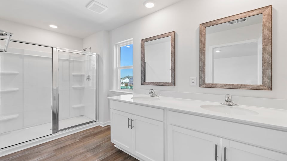 Bathroom with dual vanity and walk in shower.