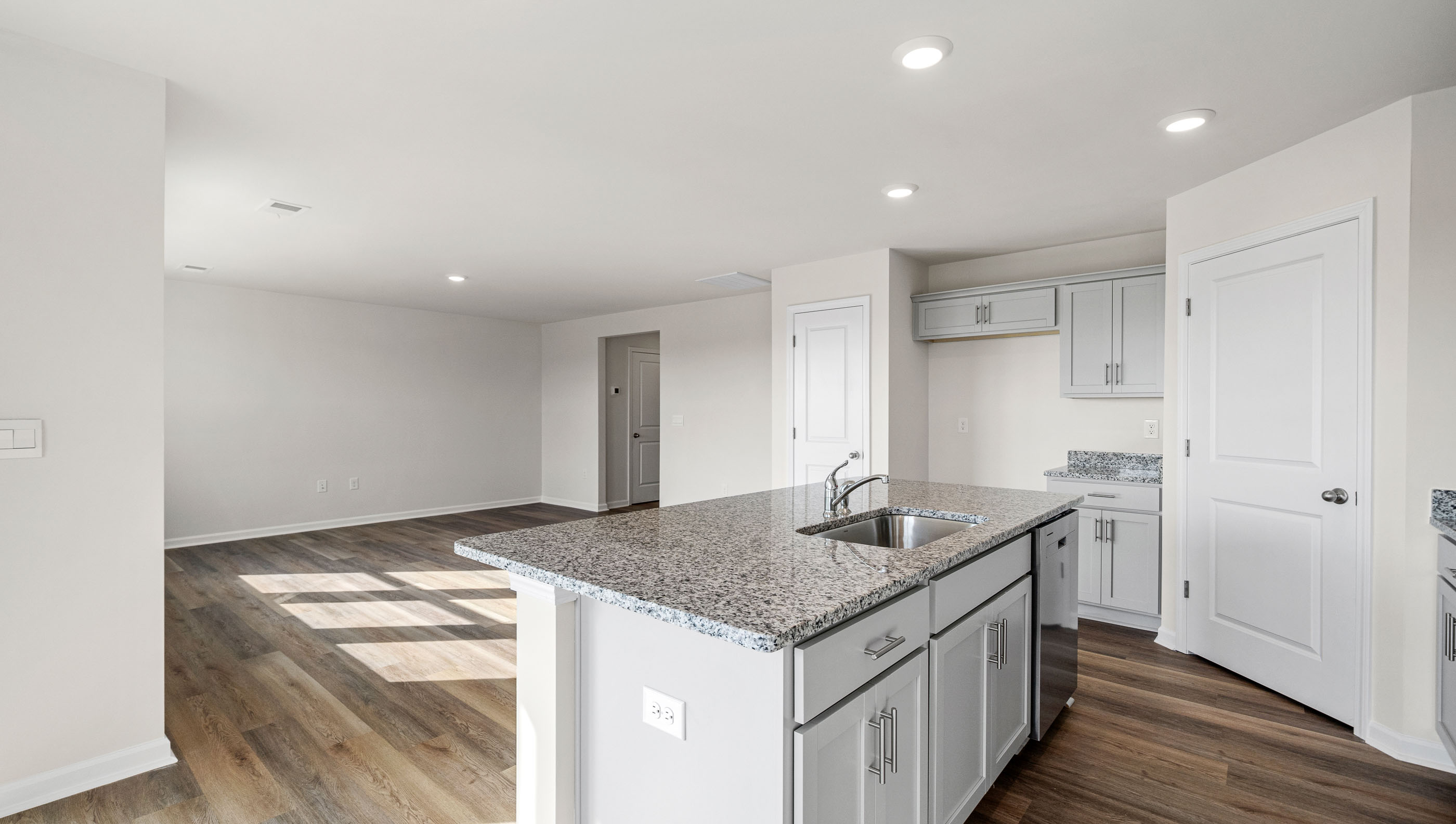 Kitchen and island with granite counter tops.