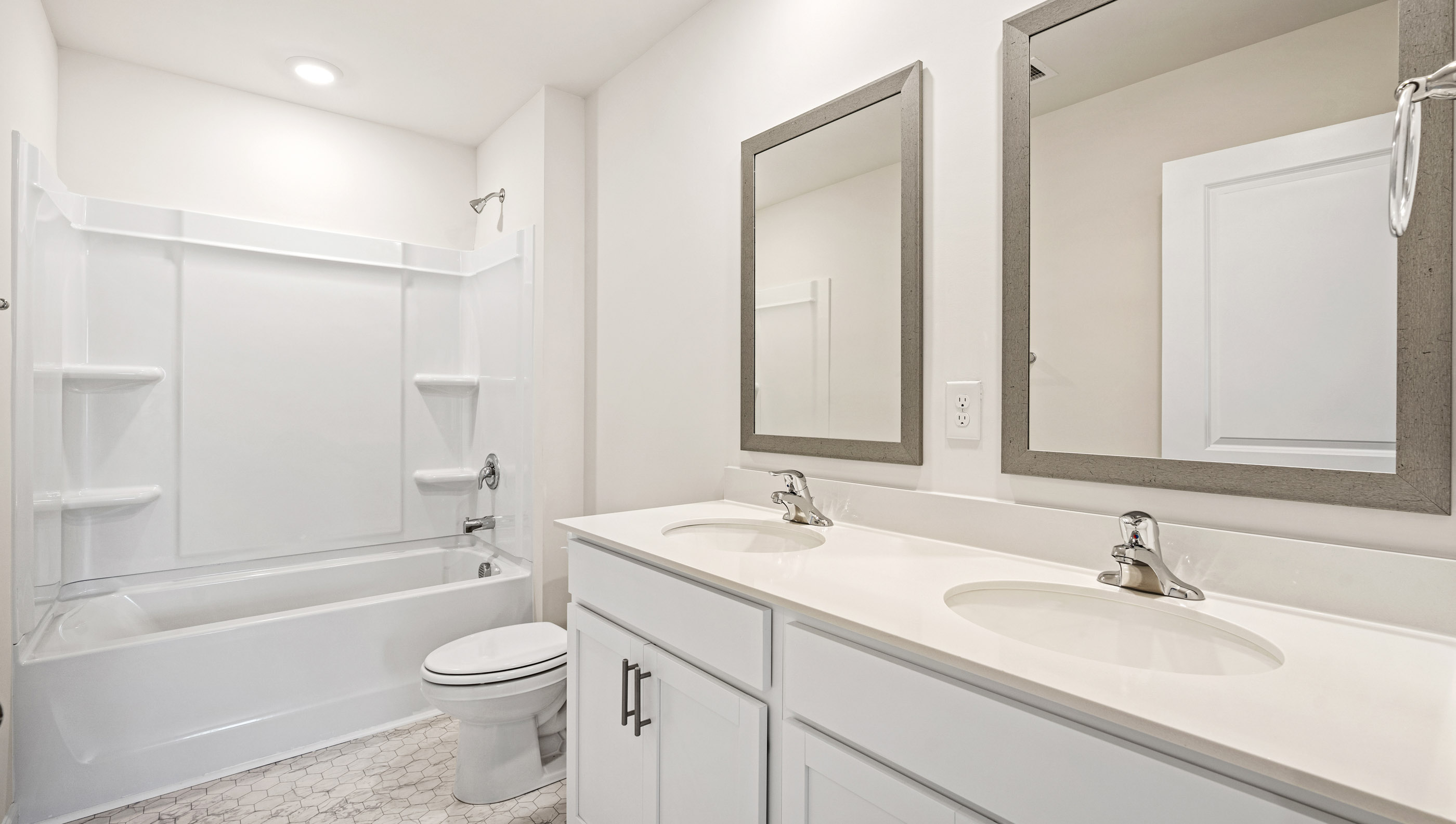Bathroom with vanities and tub.