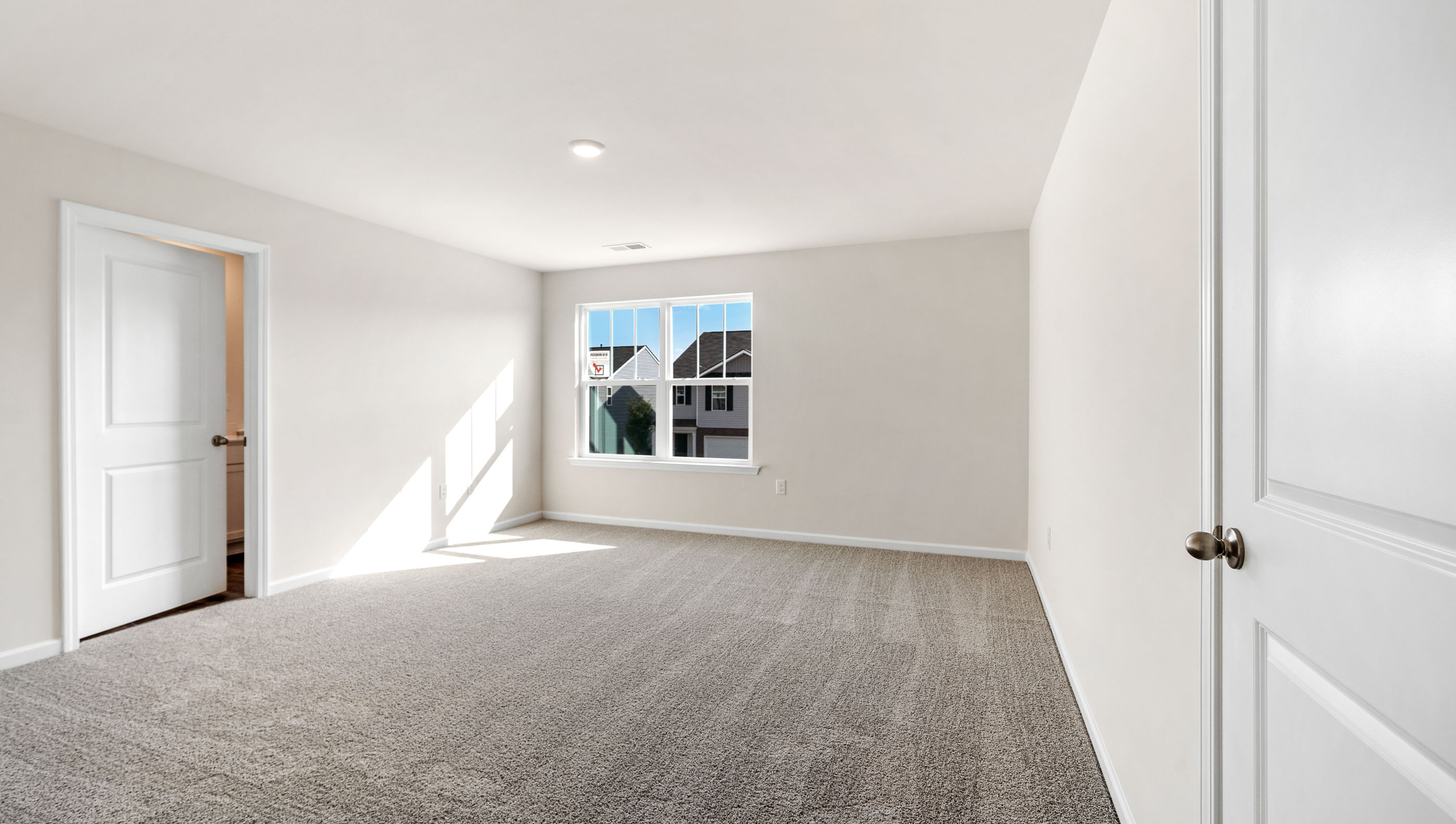 Bedroom with carpet and windows.