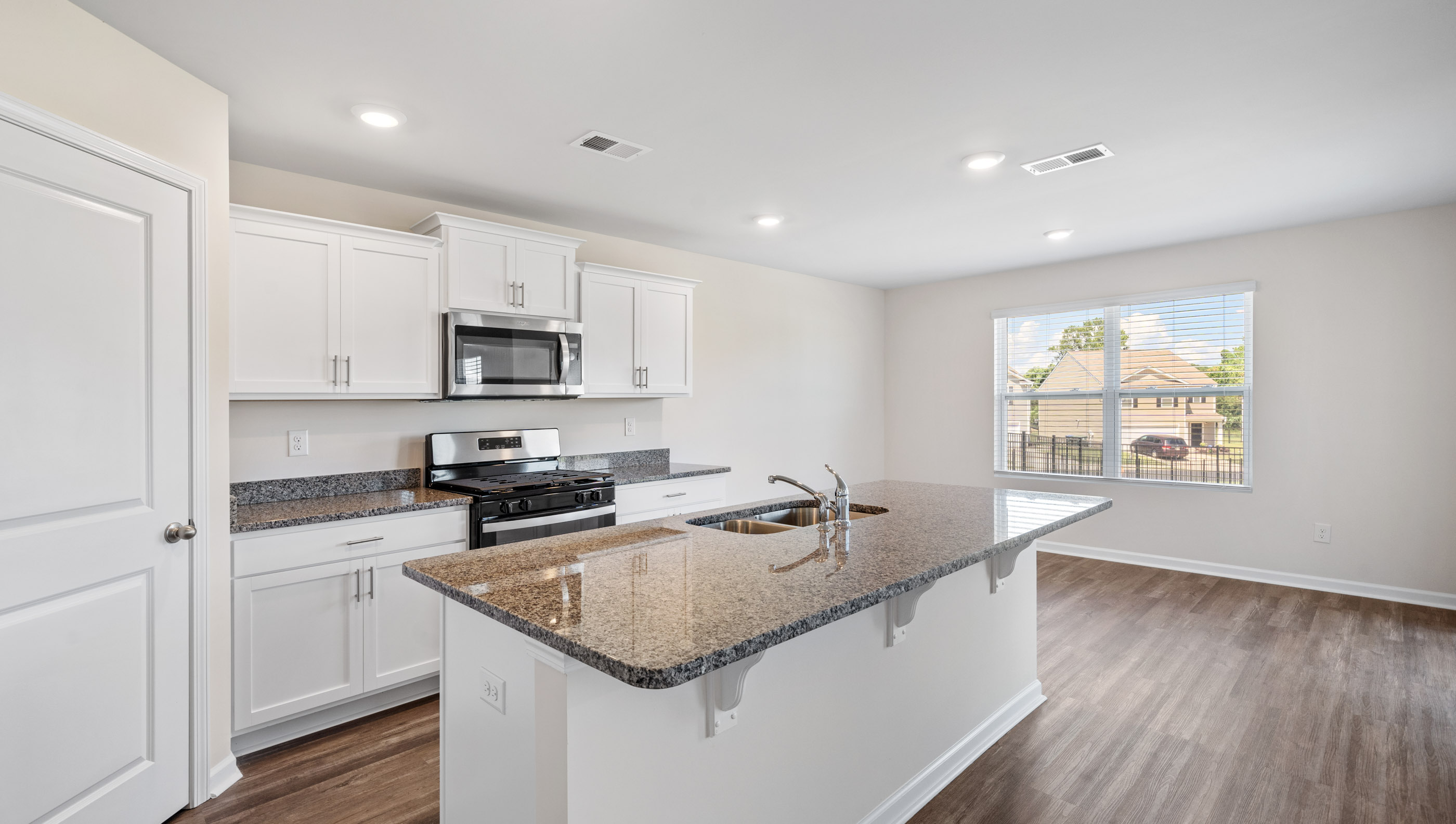 Kitchen and island with granite counter tops.