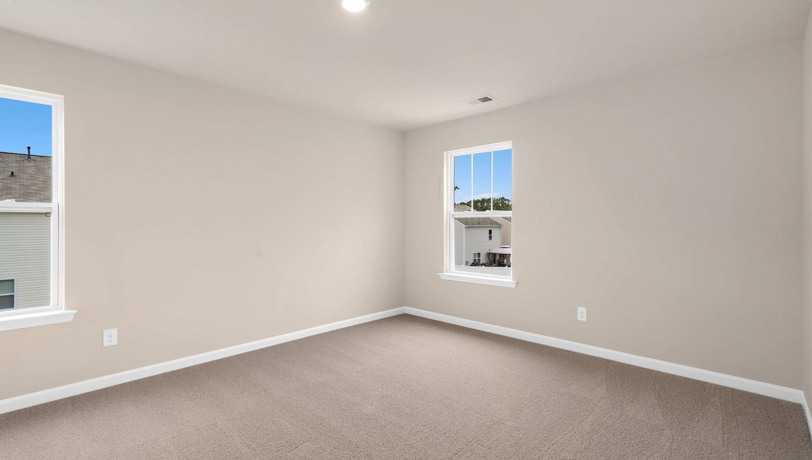 Bedroom with carpet and window.