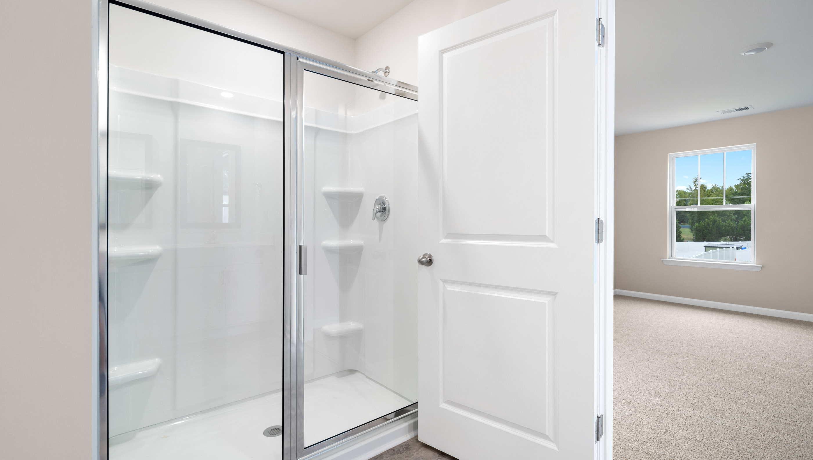 Bathroom with walk in shower and sink.