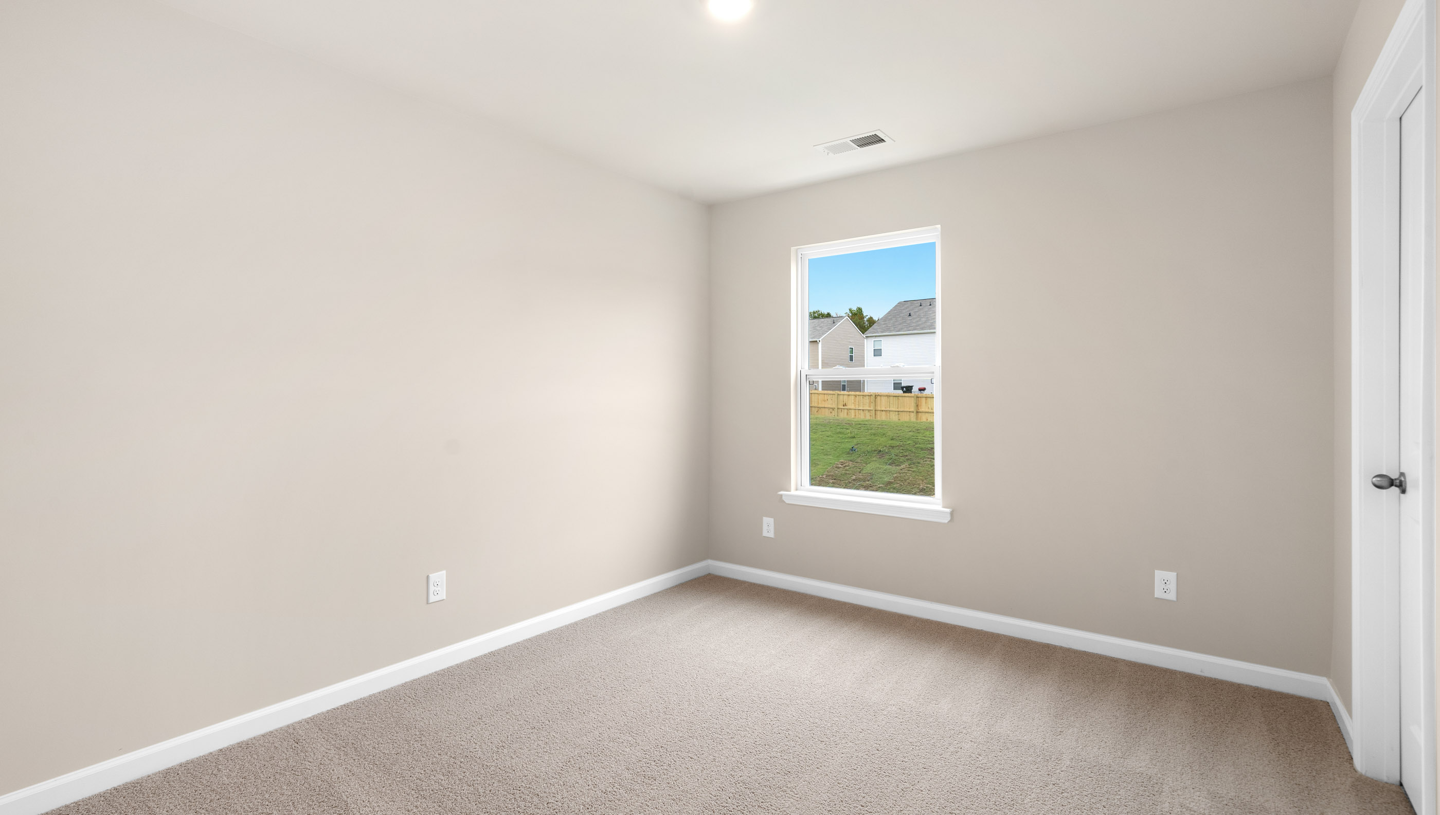 Bedroom with carpet and widow.