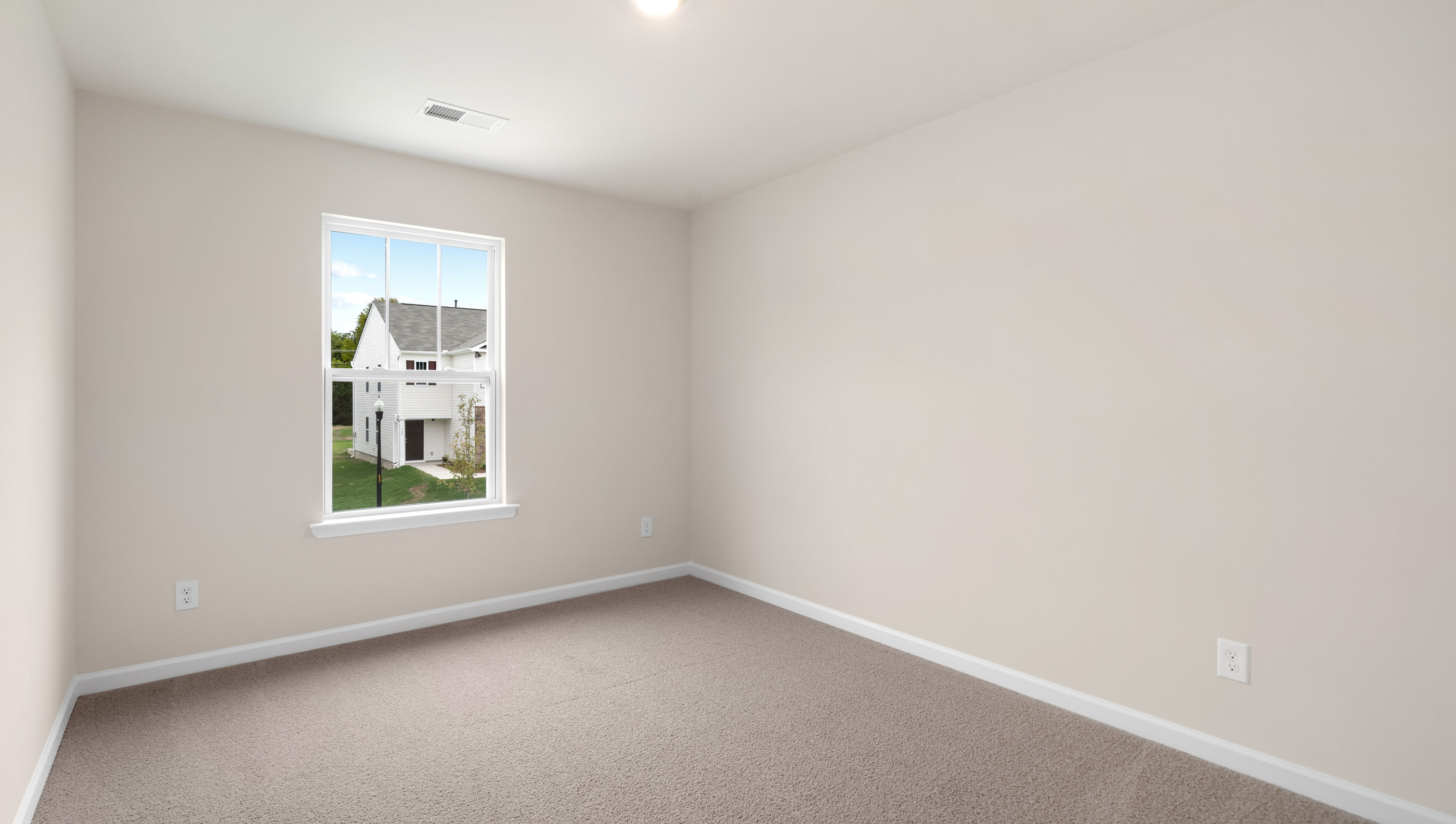 Bedroom with carpet and window.