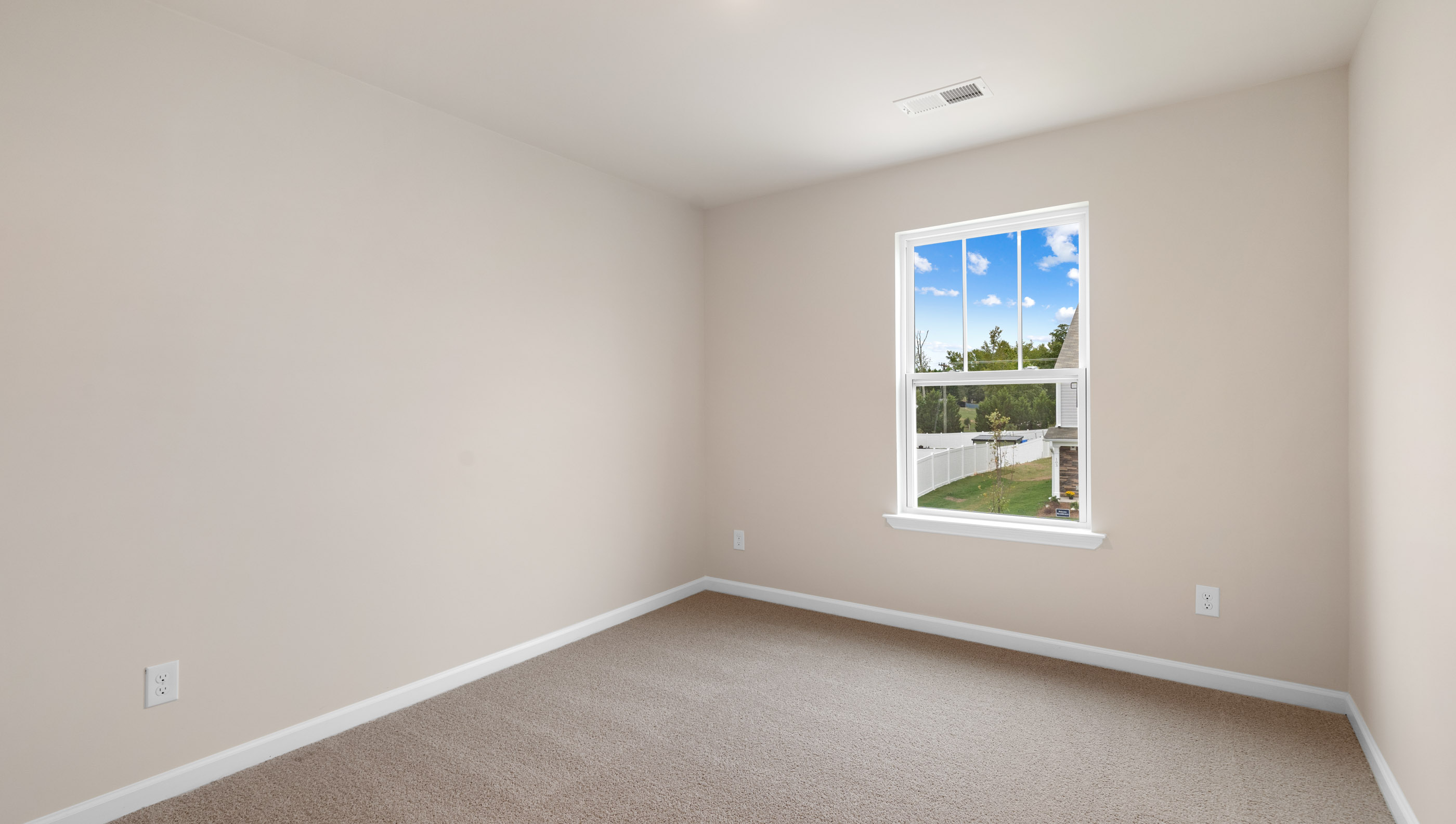Bedroom with carpet and window.