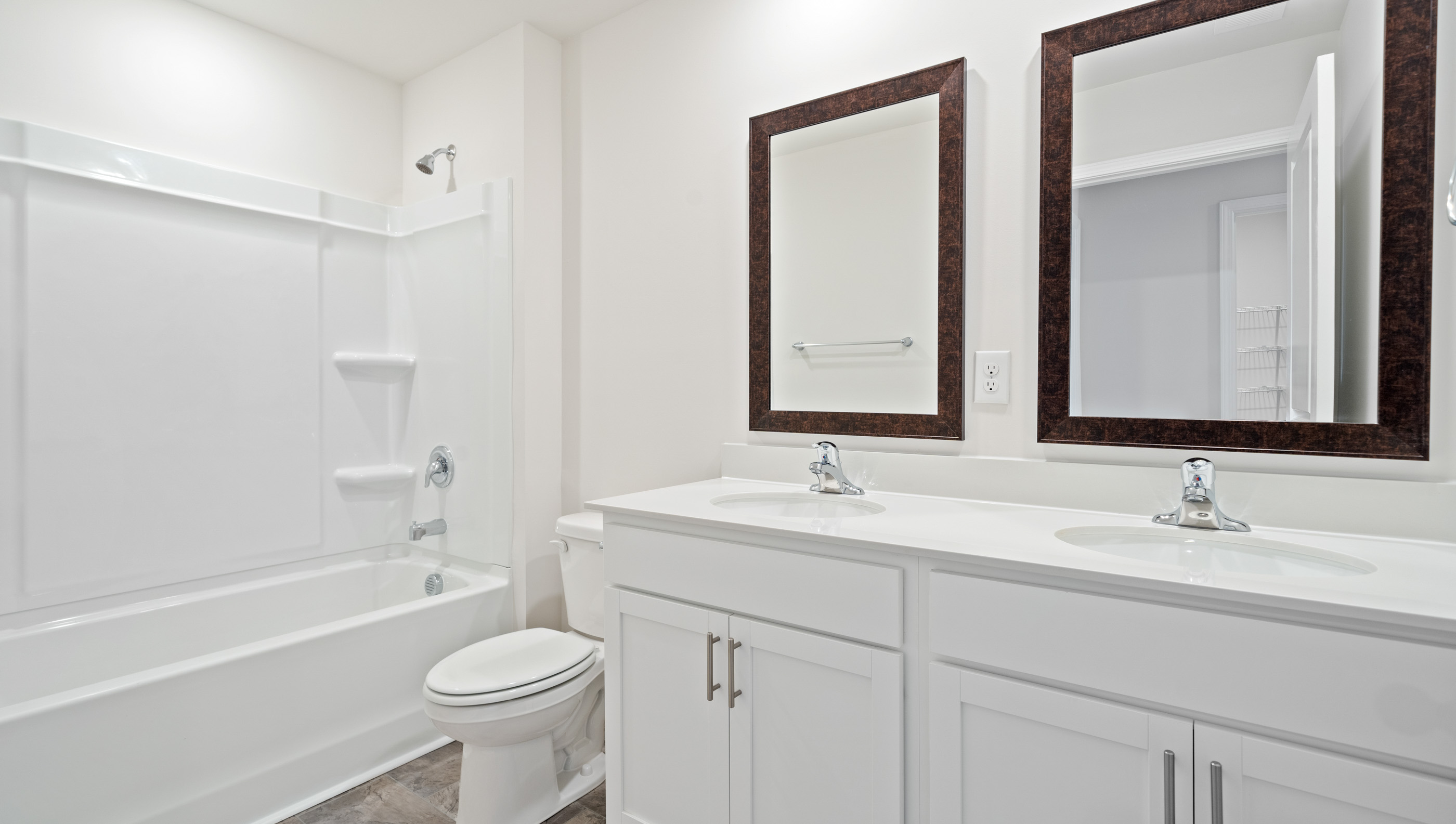 Bathroom with shower and double vanity sink.