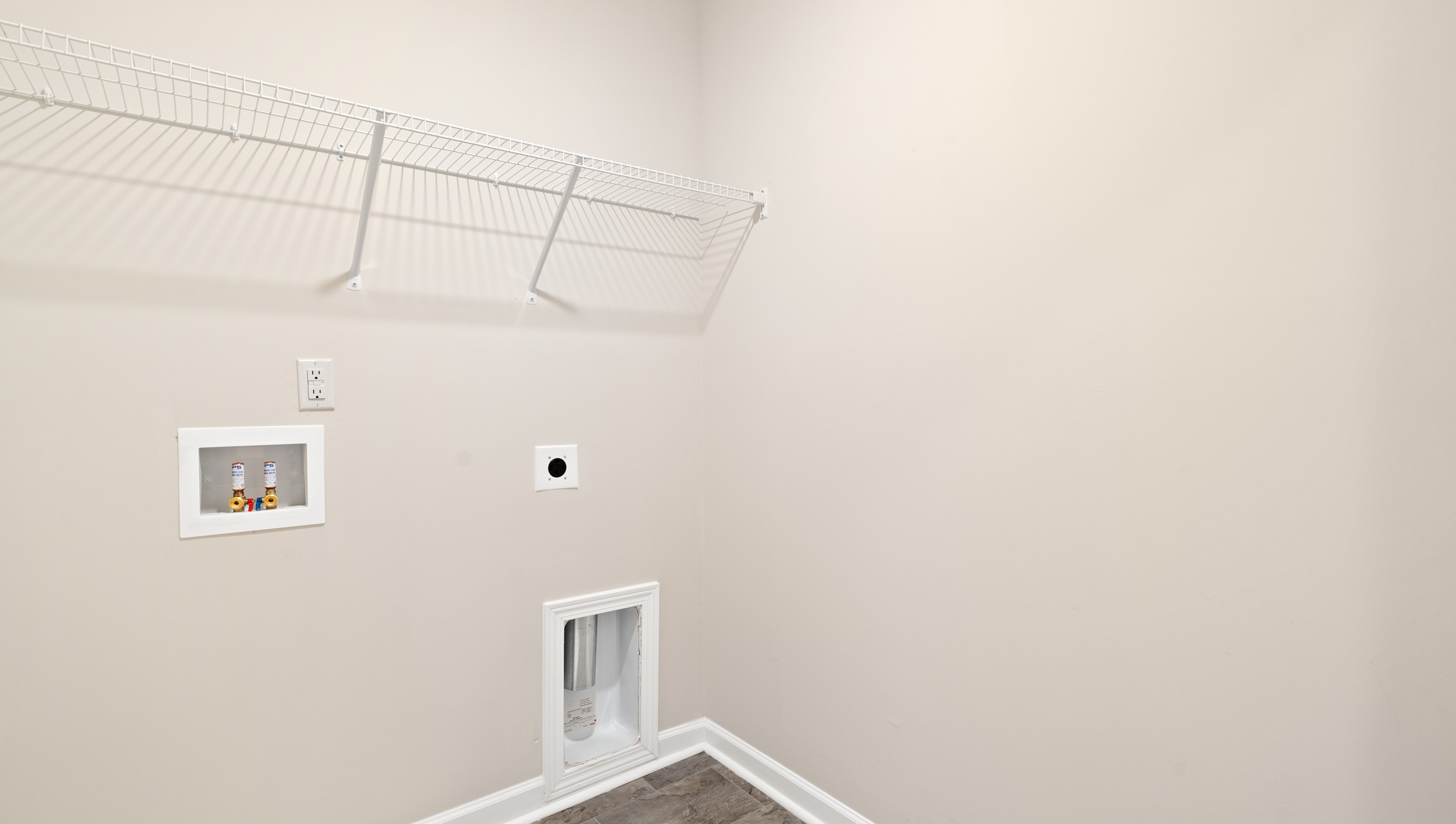 Laundry room with hanging storage racks.