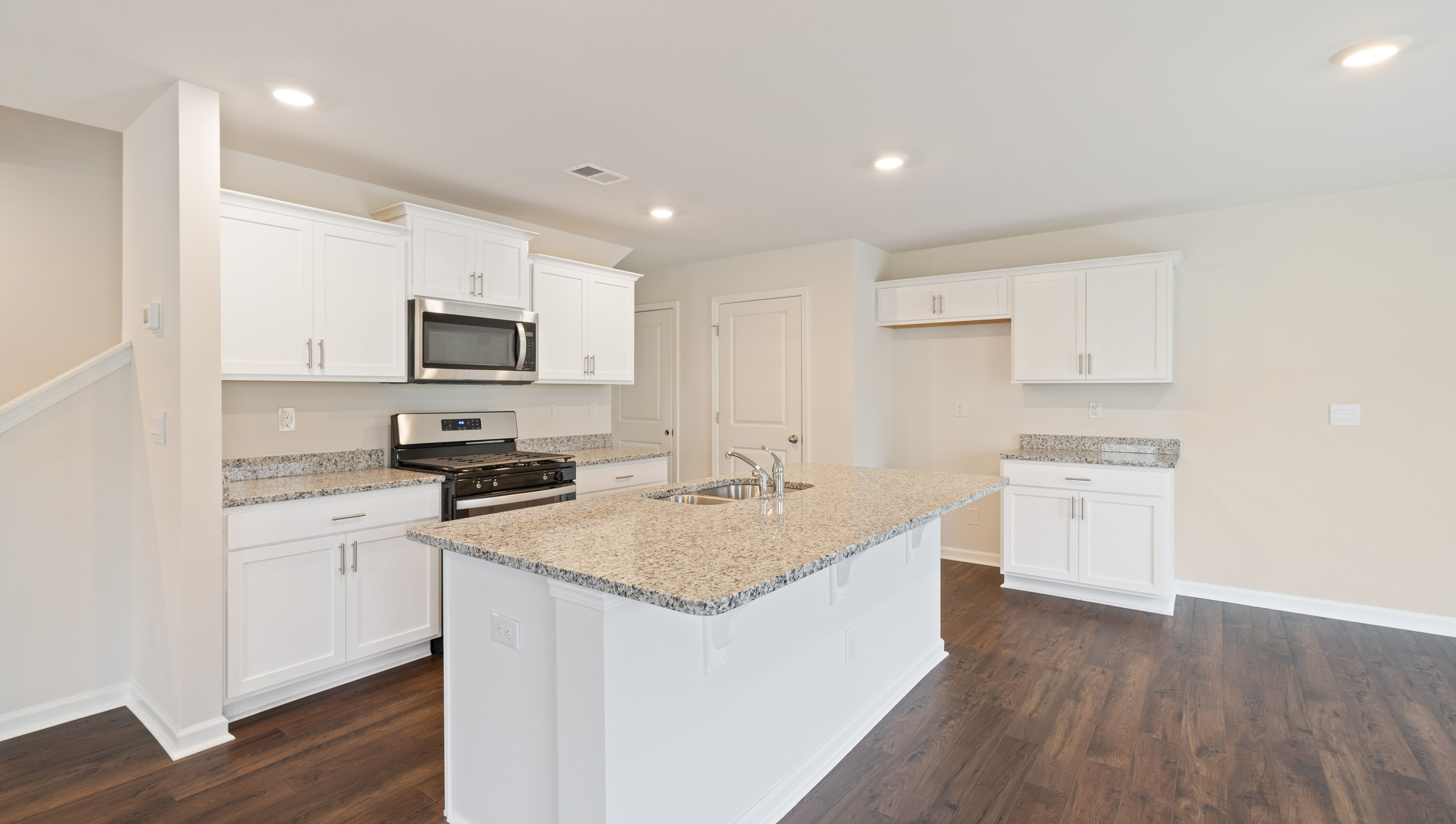 Kitchen and island with granite counter tops.