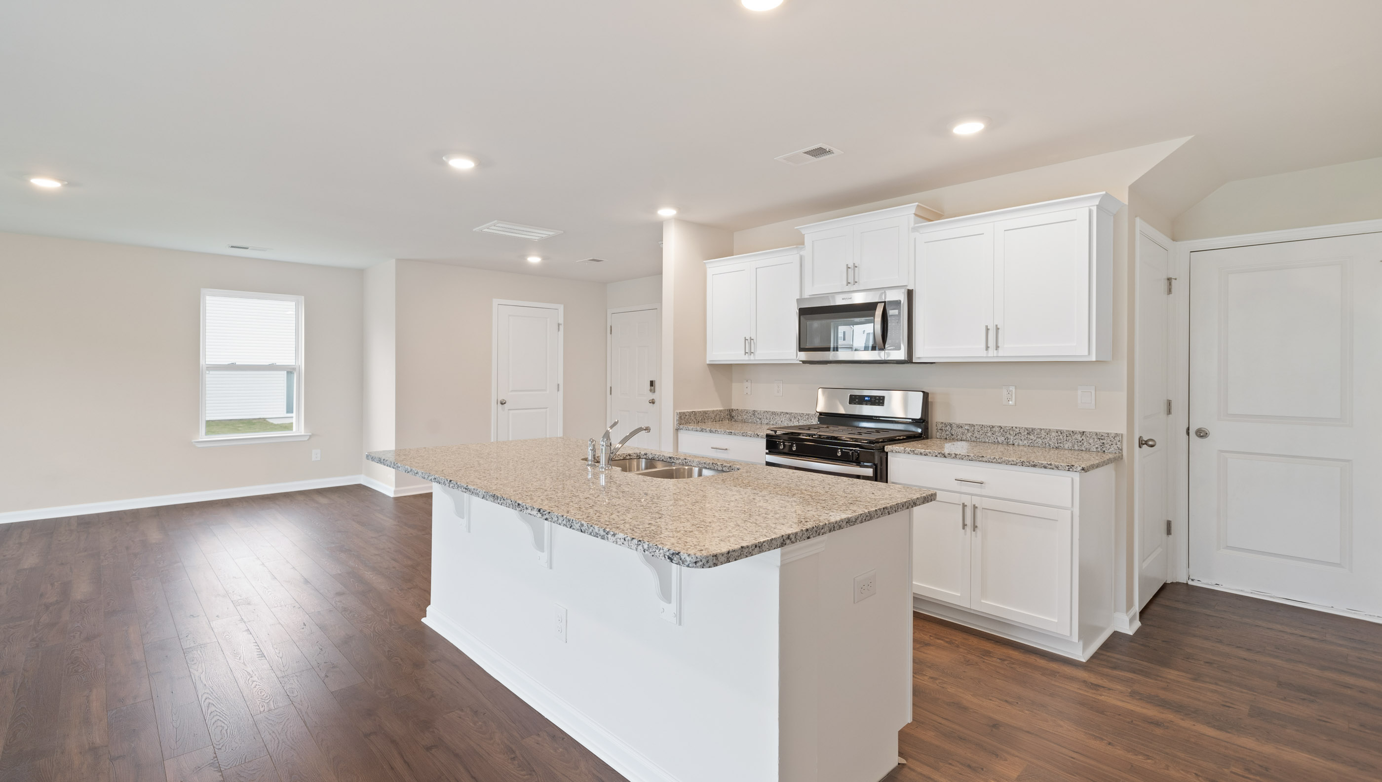 Kitchen and island with granite counter tops.