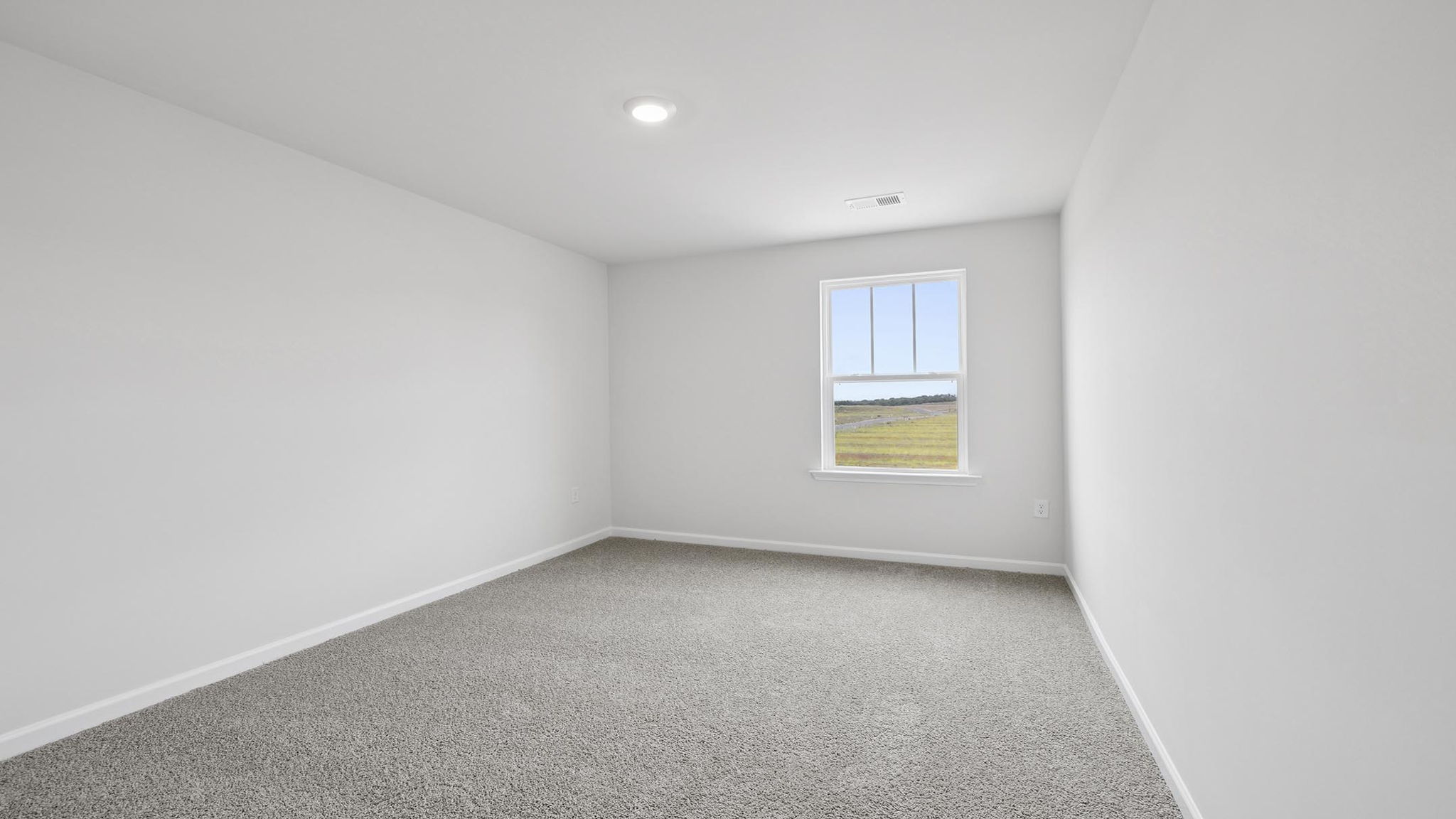 Bedroom with carpet and window.