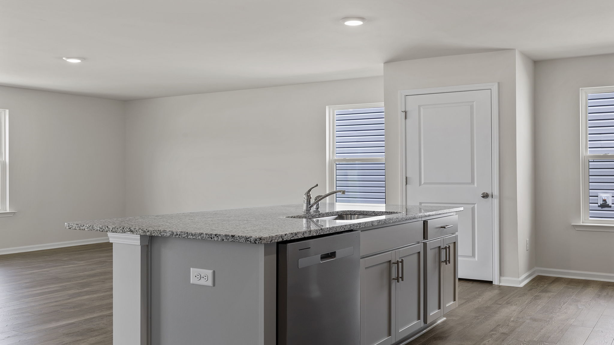 Kitchen with island and granite countertop.