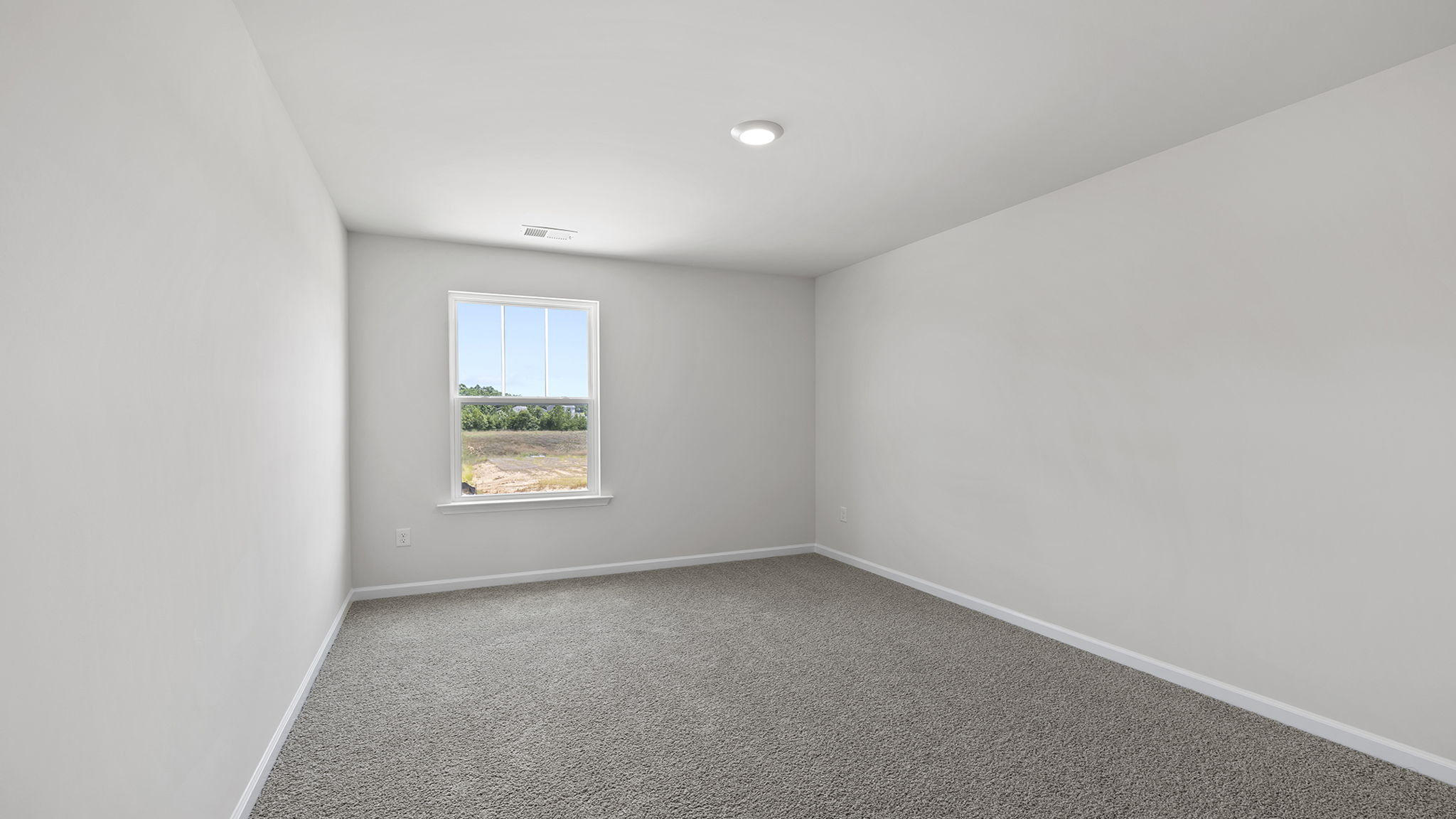 Bedroom with carpet and window.