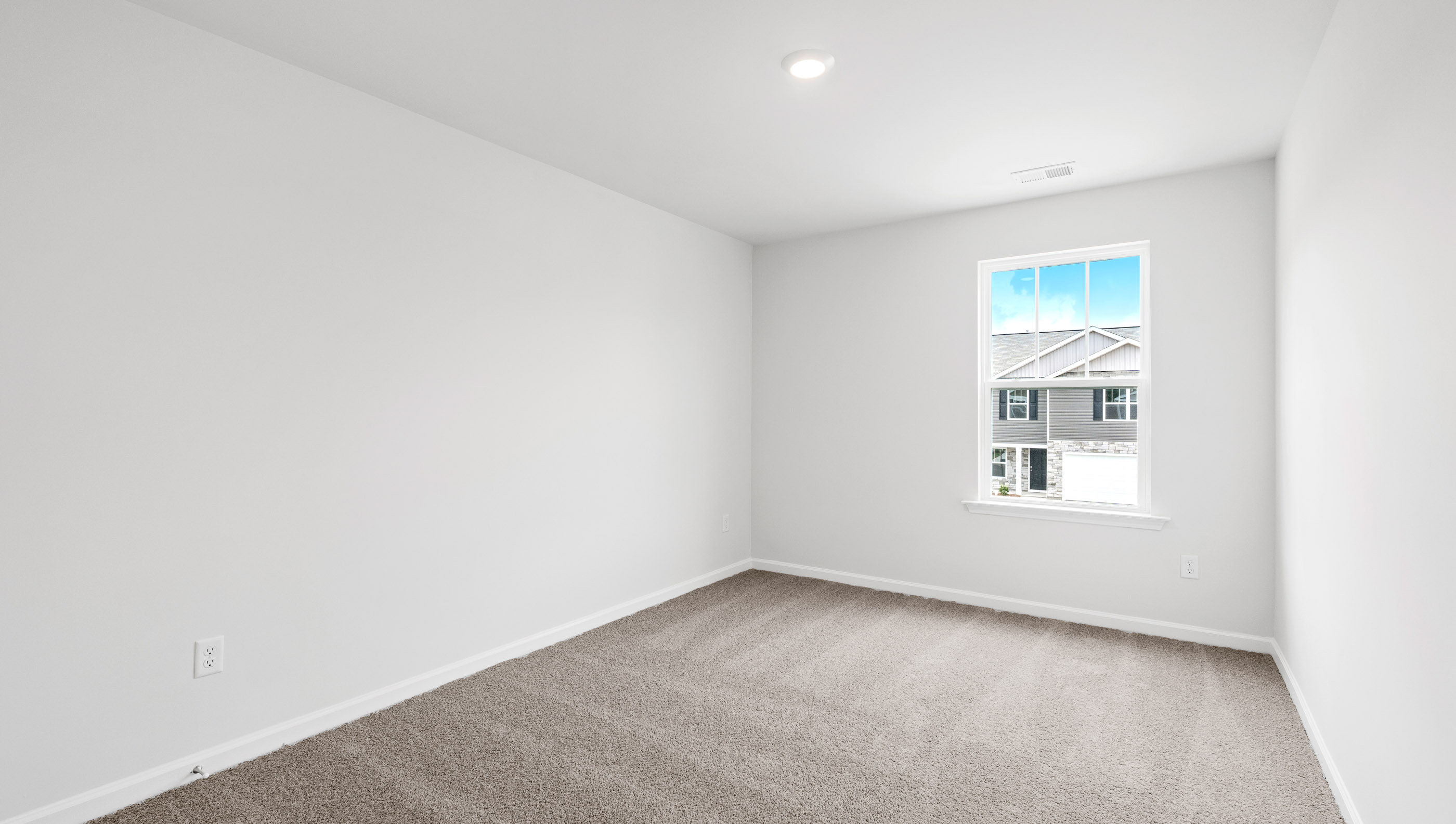 Bedroom with carpet and window.