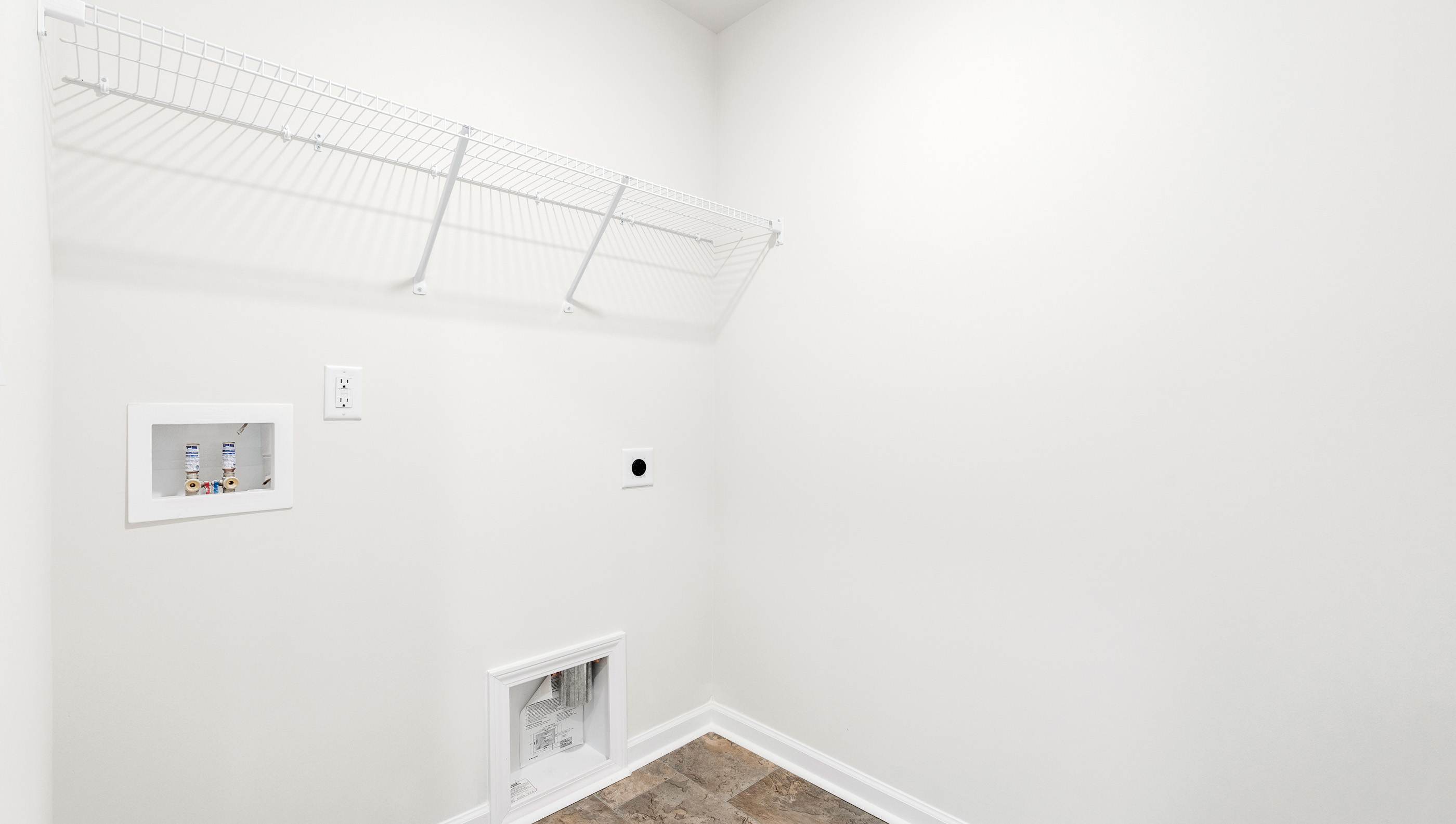 Walk in laundry with hanging shelves.