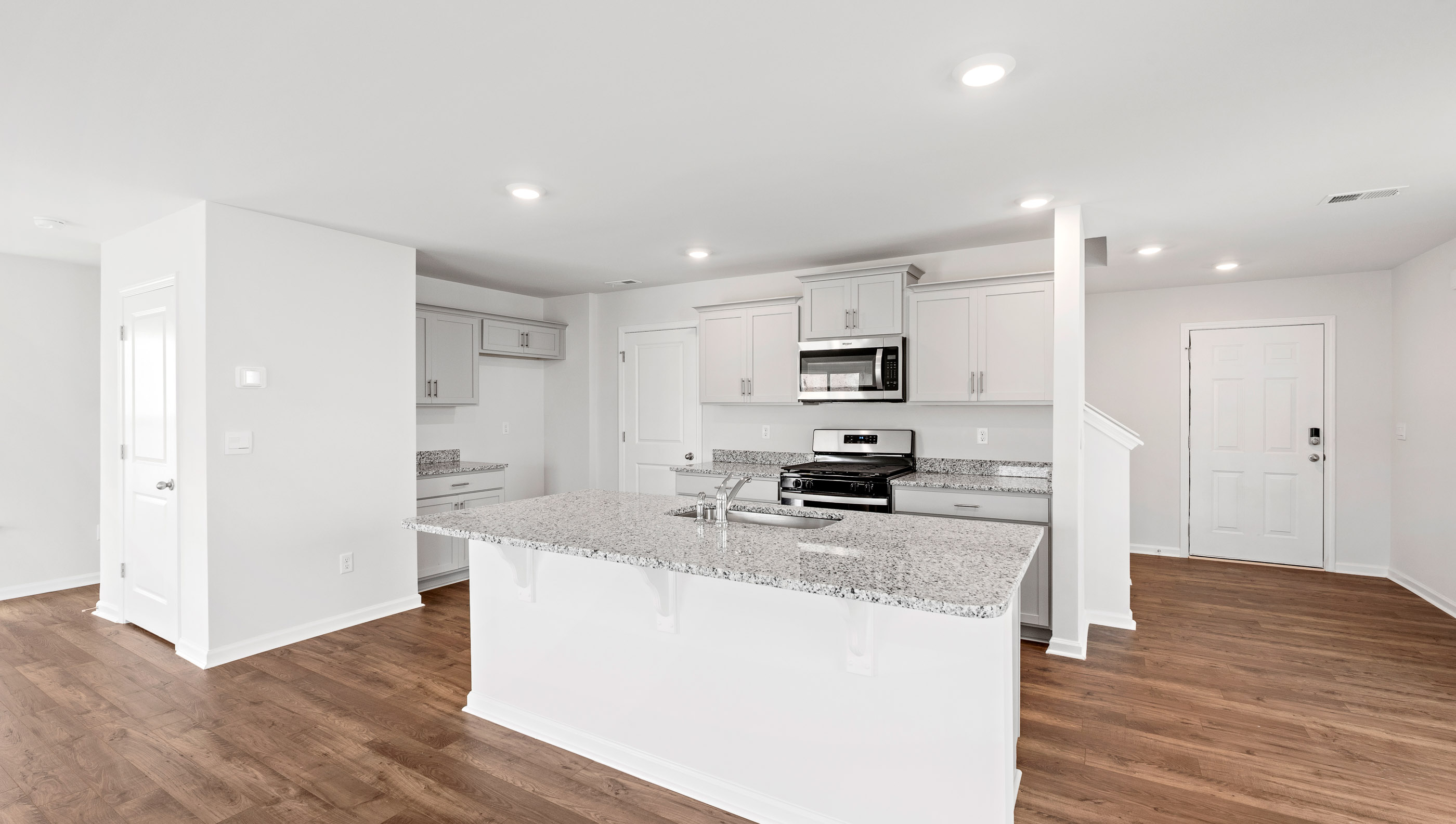 Kitchen and island with granite countertop.