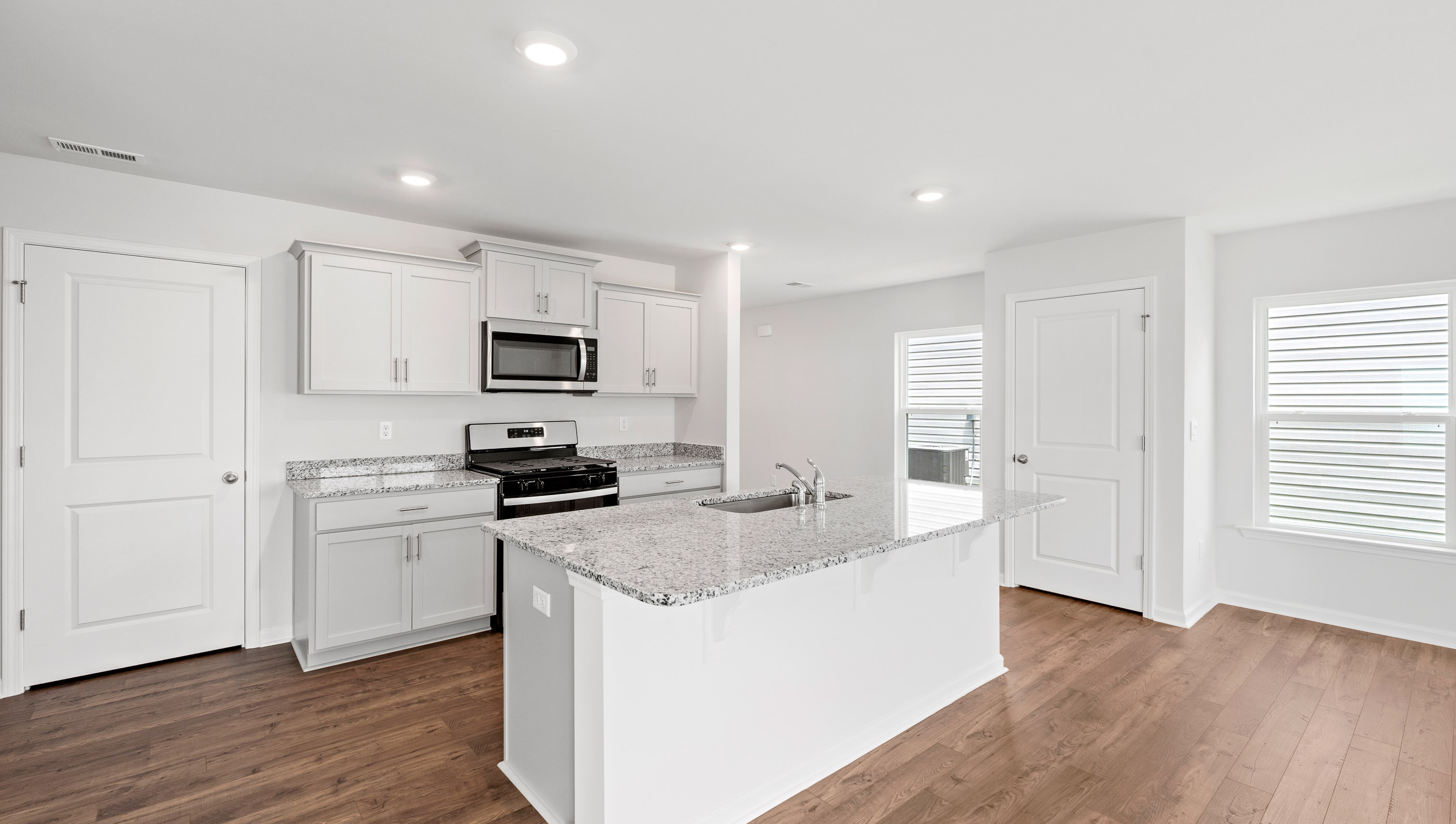 Kitchen and island with granite countertop.