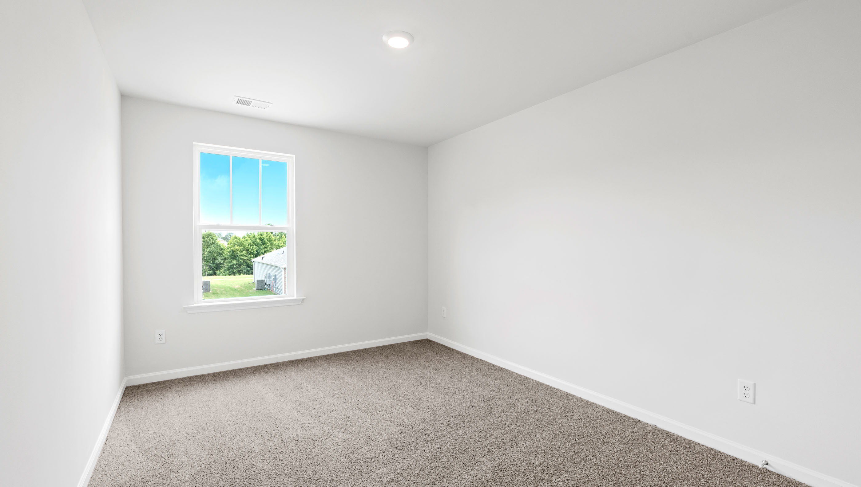 Bedroom with carpet and window.