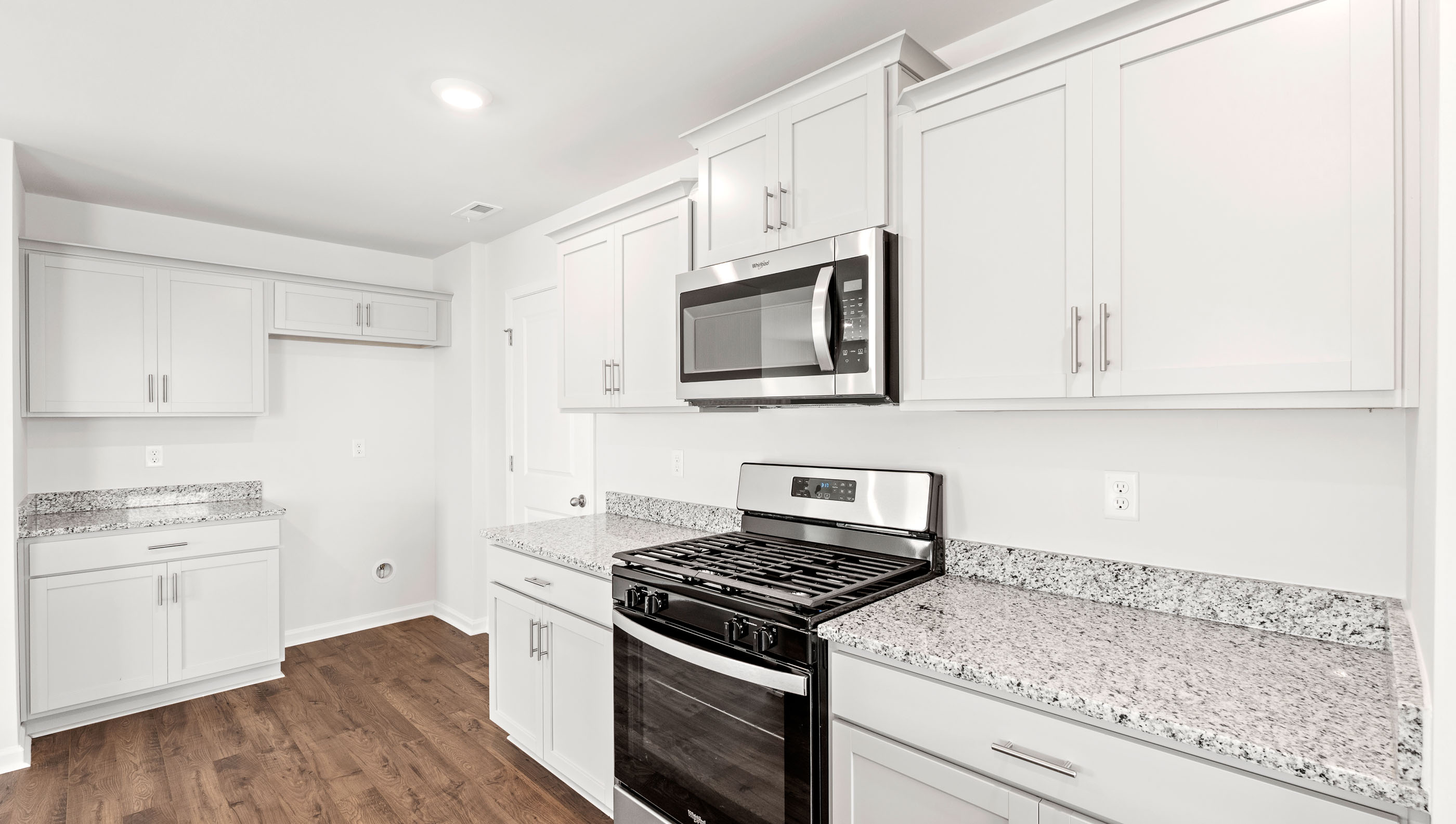 Kitchen with granite countertop and stainless steel appliances.