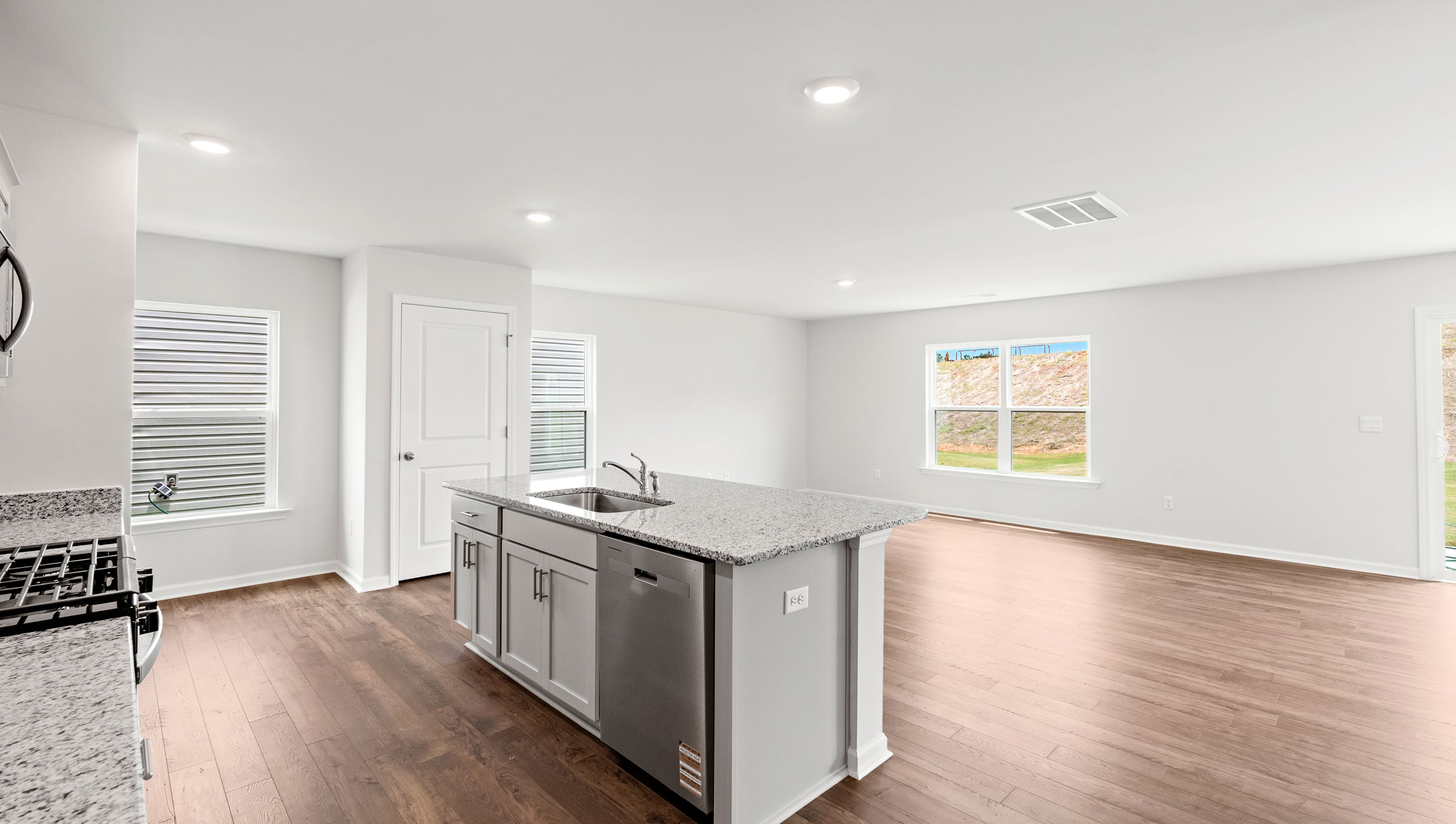 Kitchen and island with granite countertop.