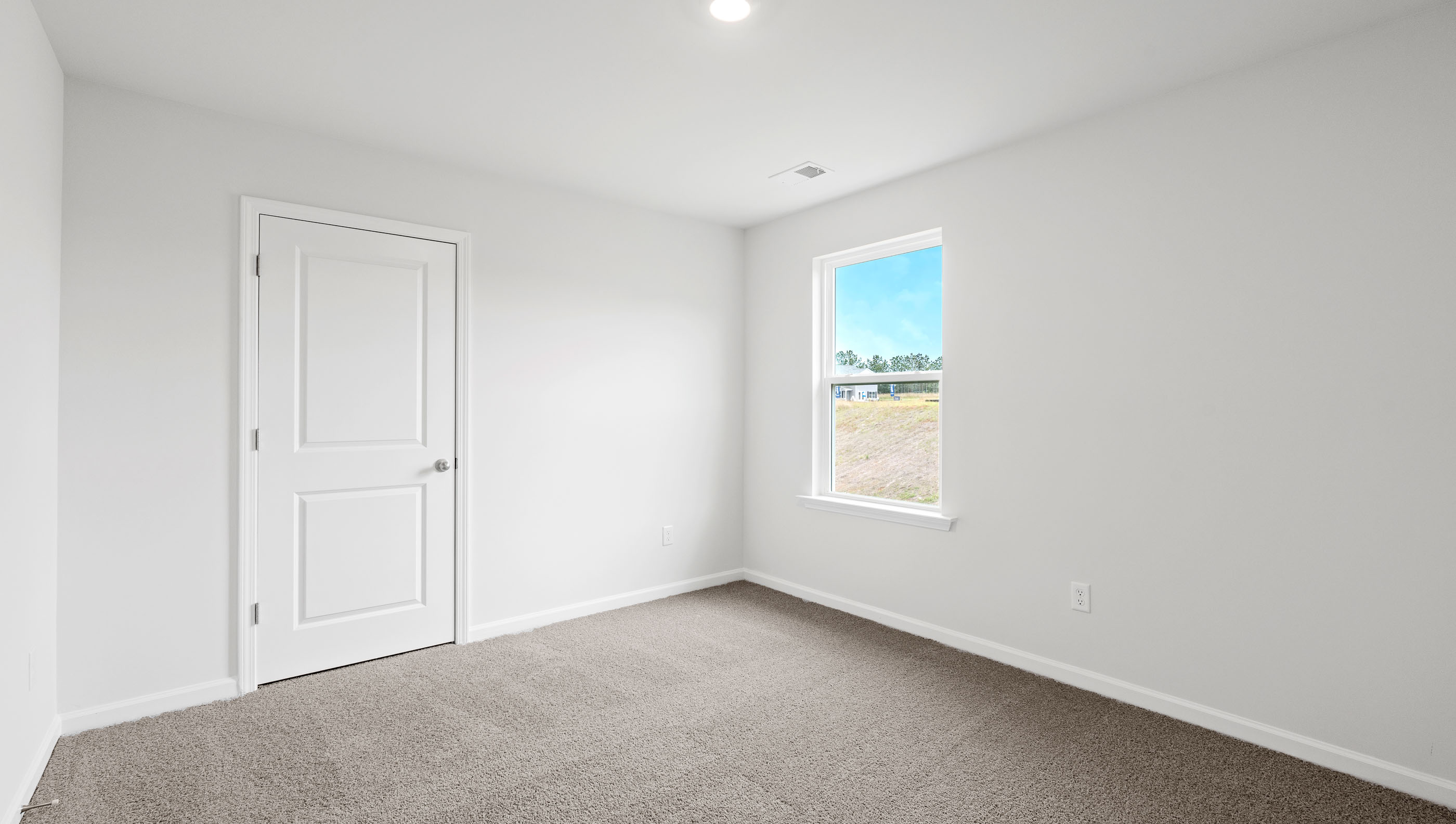 Bedroom with carpet and window.