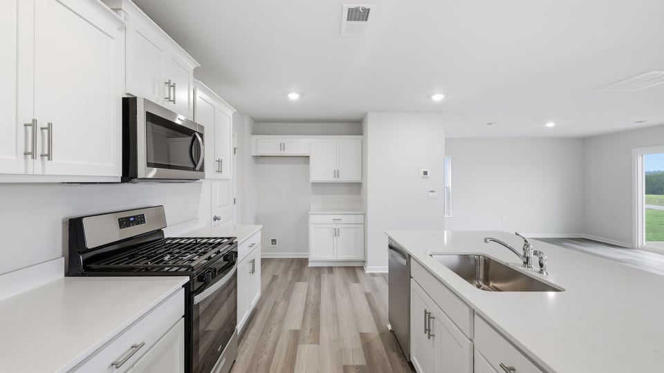 Kitchen and island with stainless steel appliances.