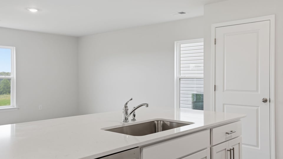 Kitchen and island with stainless steel appliances.