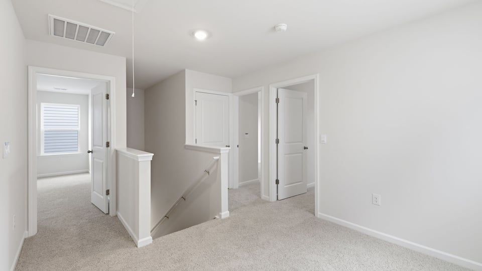 Loft area with carpet.