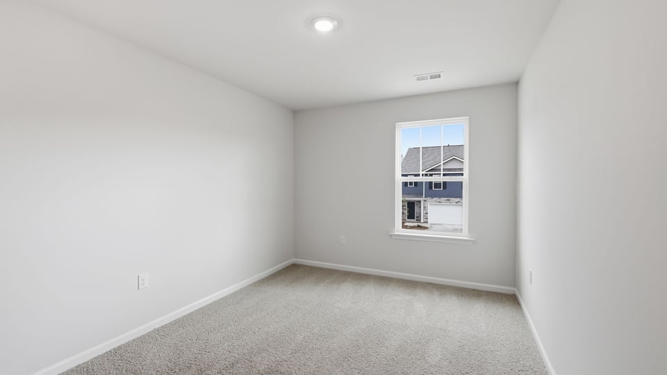 Bedroom with carpet and window.