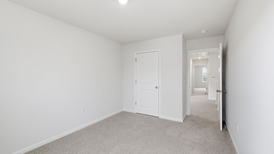 Bedroom with carpet and window.
