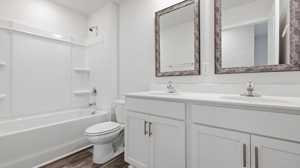 Bathroom with double vanity sink and bathtub.