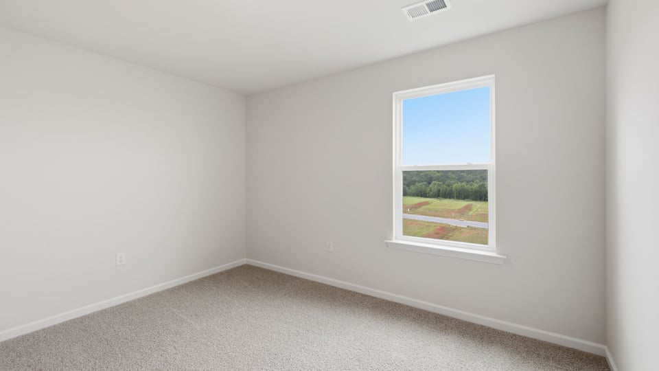 Bedroom with carpet and window.