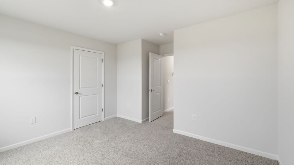 Bedroom with carpet and window.