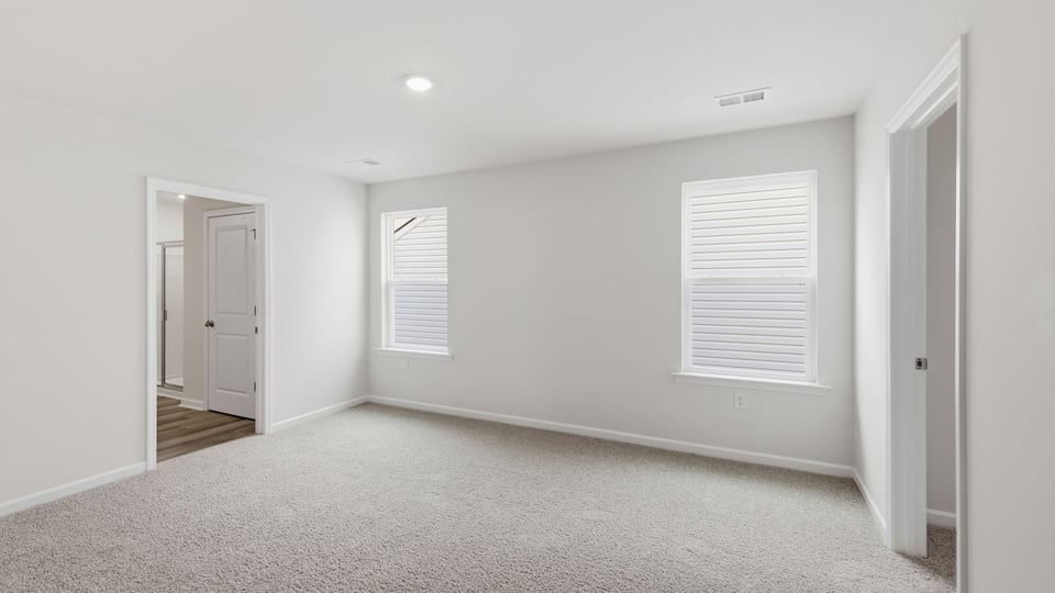 Bedroom with carpet and window.