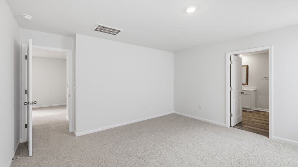 Bedroom with carpet and window.