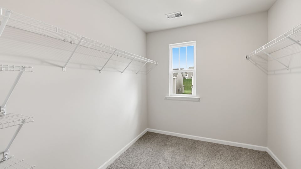 Closet with carpet and window.