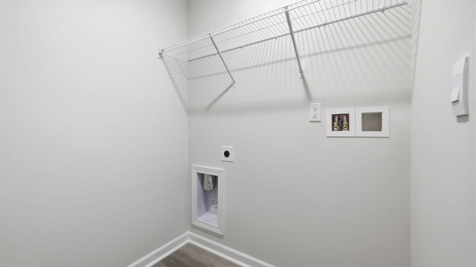Laundry room with hanging storage racks.