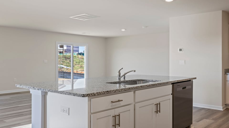 Kitchen and island with granite countertops.