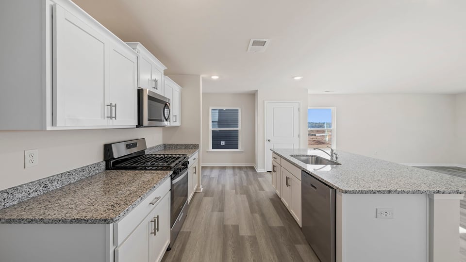 Kitchen and island with granite countertops.